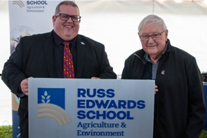 ACC President Mark Frison and Russ Edwards holding a Russ Edwards School sign