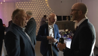 People standing in the crowd, making conversation.