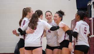 Assiniboine women's volleyball team celebrating a point.