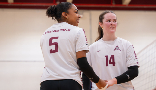 Assiniboine women's volleyball players standing together.