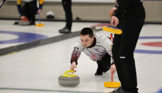 Assiniboine curler throwing a yellow rock.