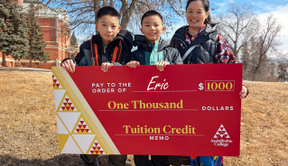 Eric Y. and his family holding a big red cheque.