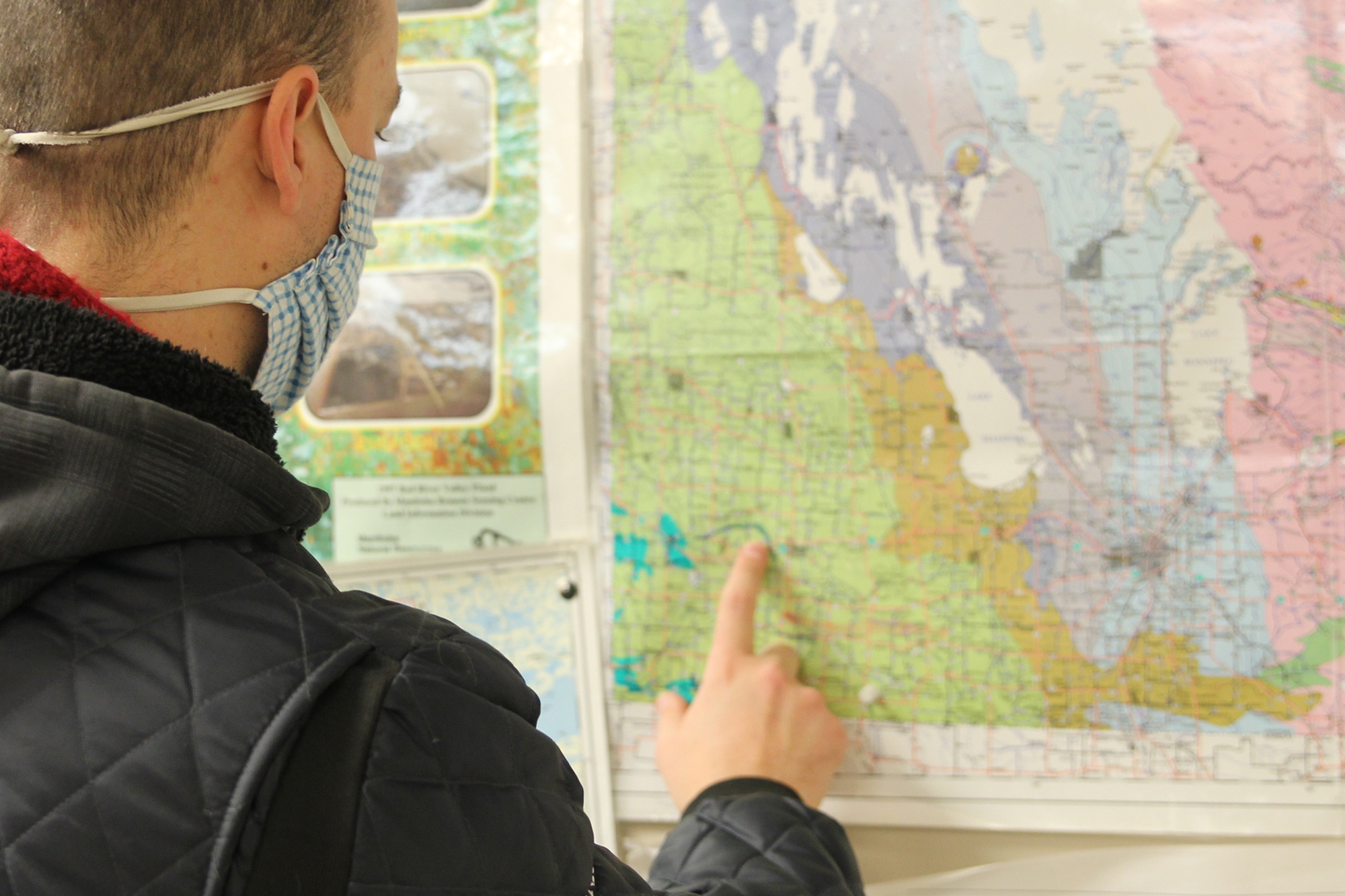 Joe Dauphinais pointing at a region on a map.