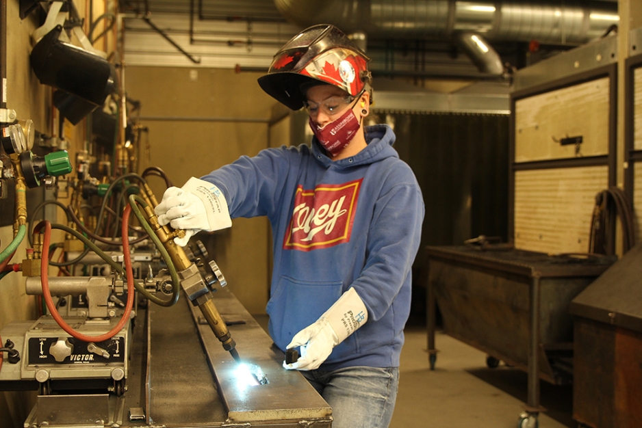 Heather Bruederlin welding in shop.