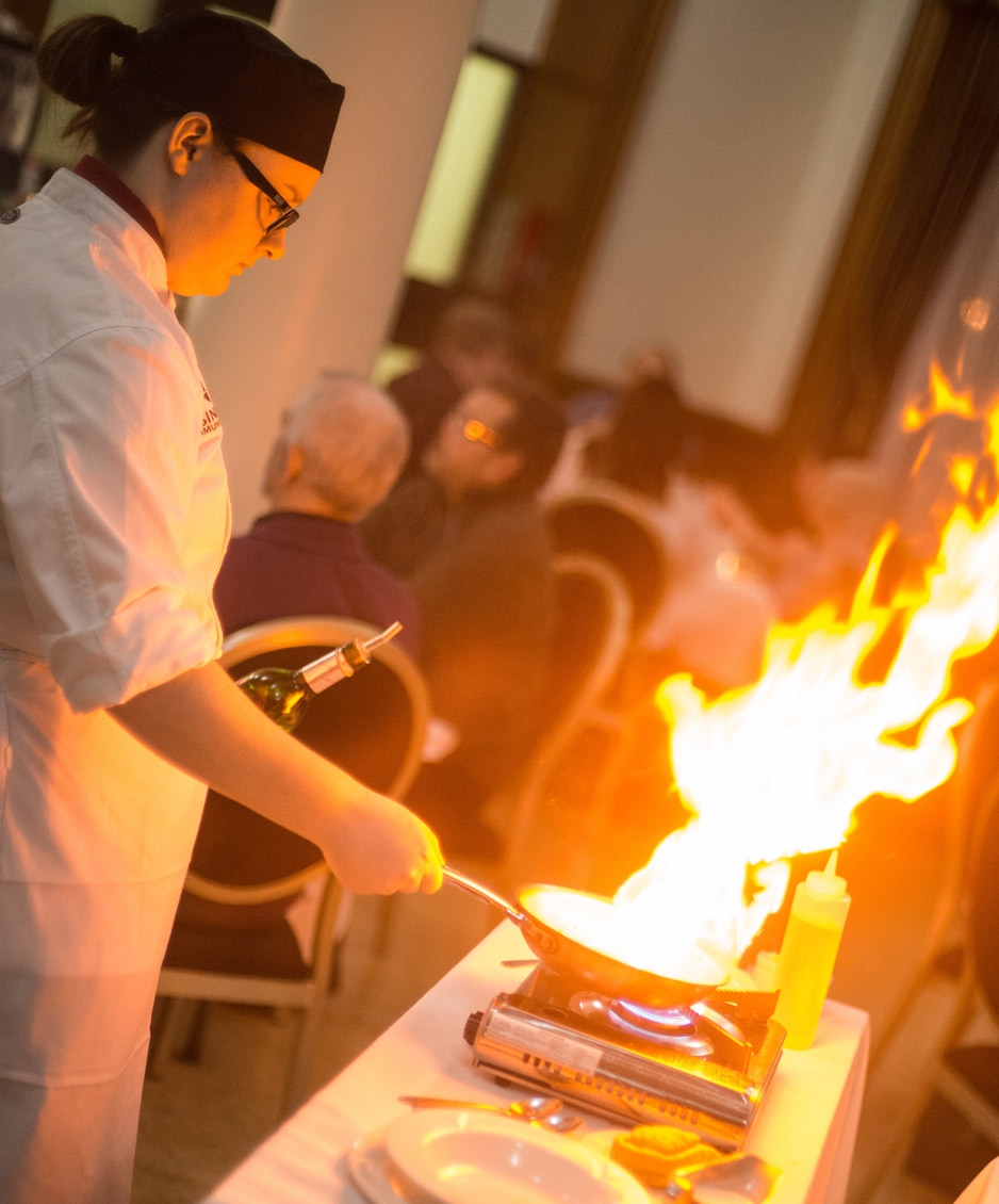 Culinary Arts student showing off flambé