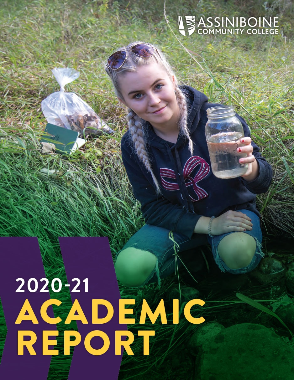 Female student crouches in field holding jar of water.