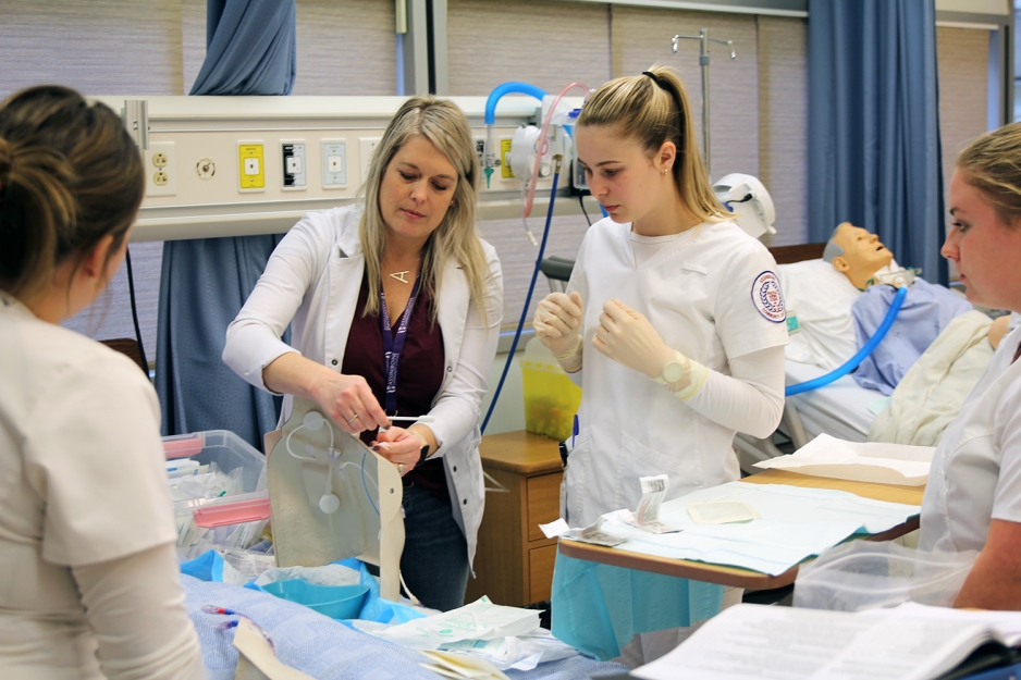 Students with instructor working in a nursing lab.