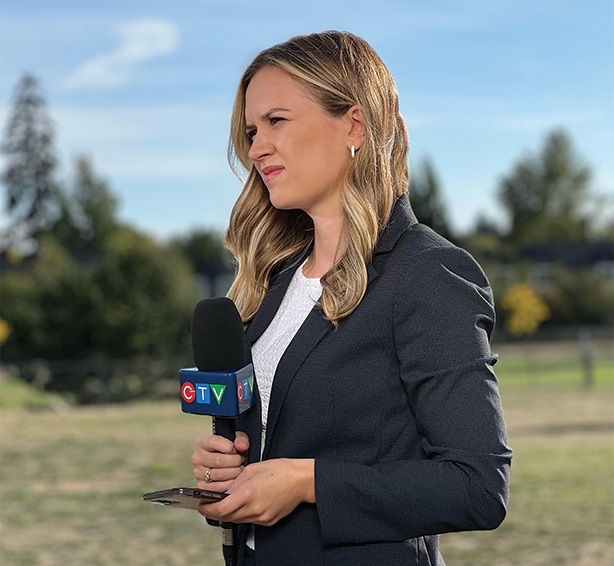 Abigail Turner standing with a CTV microphone with trees in the background.