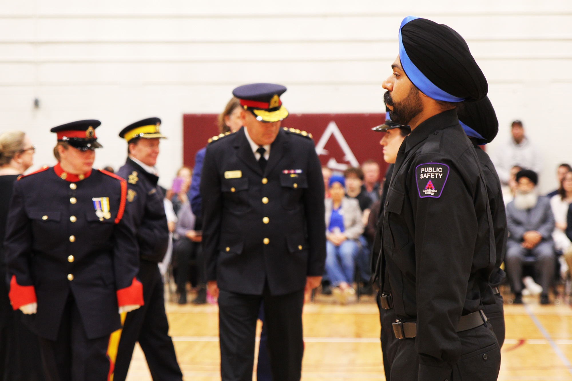 Final inspection 2025 Police Officer inspecting student at Assiniboine Final Inspection 2025,