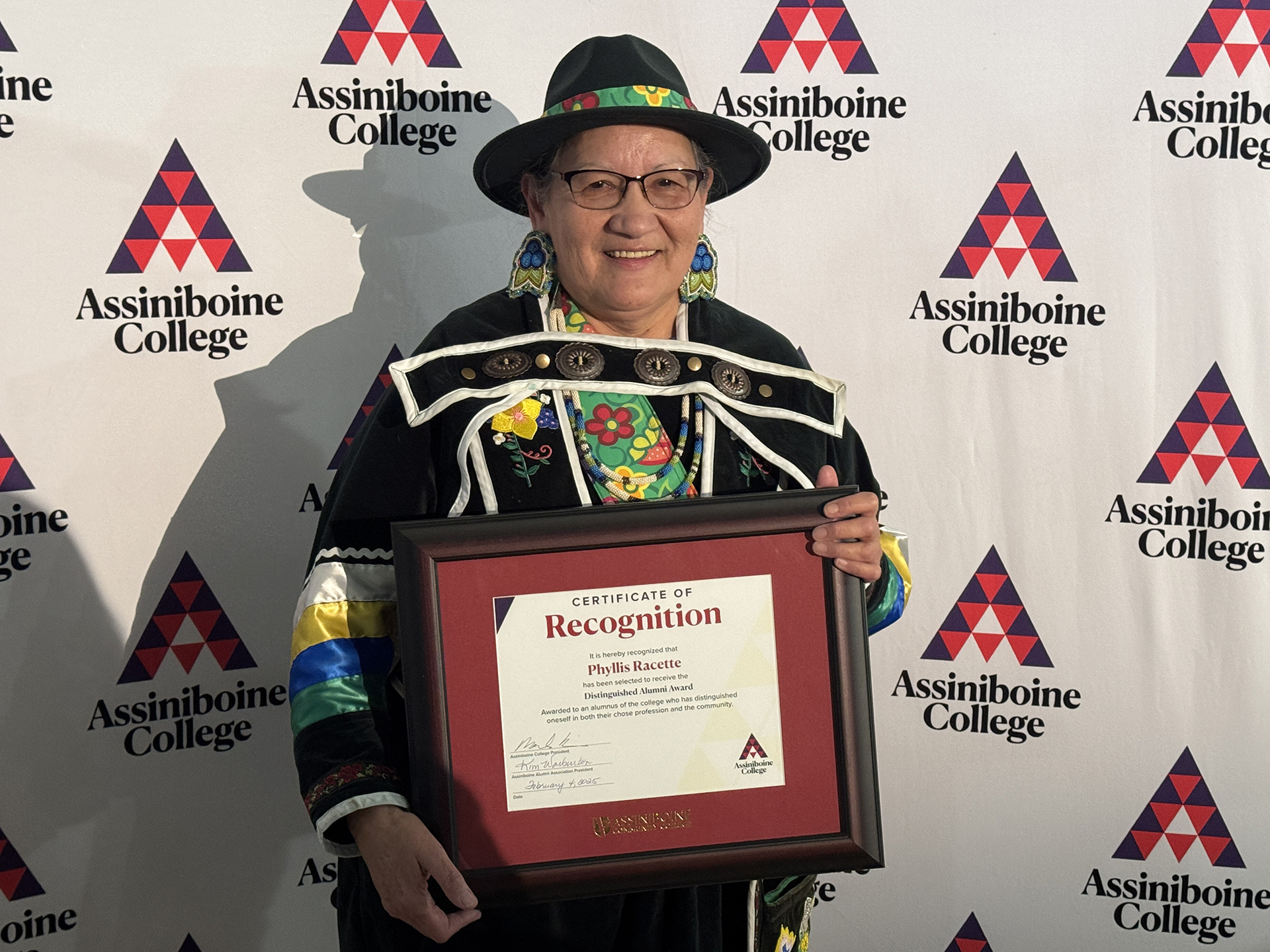 Phyllis Racette posing with her Alumni Awards certificate.