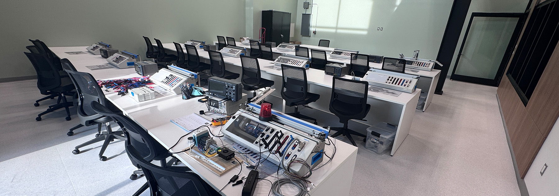 A room with rows of desks and electronic components on them.