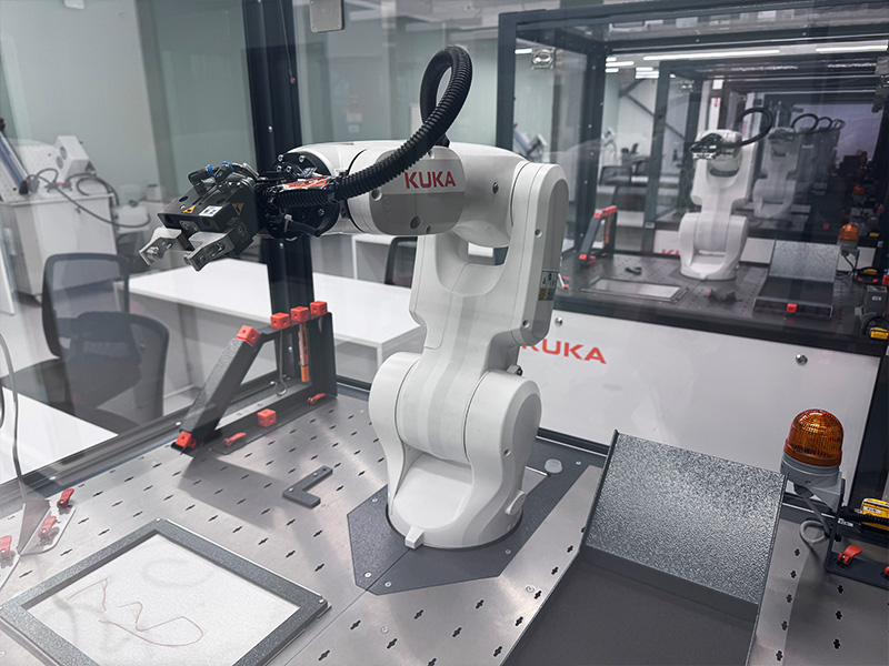 Kuka robotic cell close-up photo.