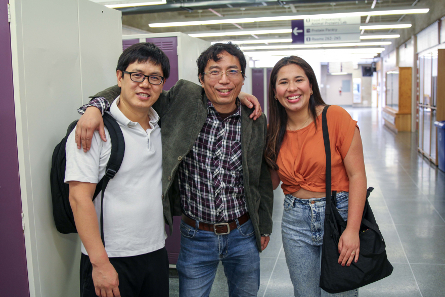 Three international students in hallway.
