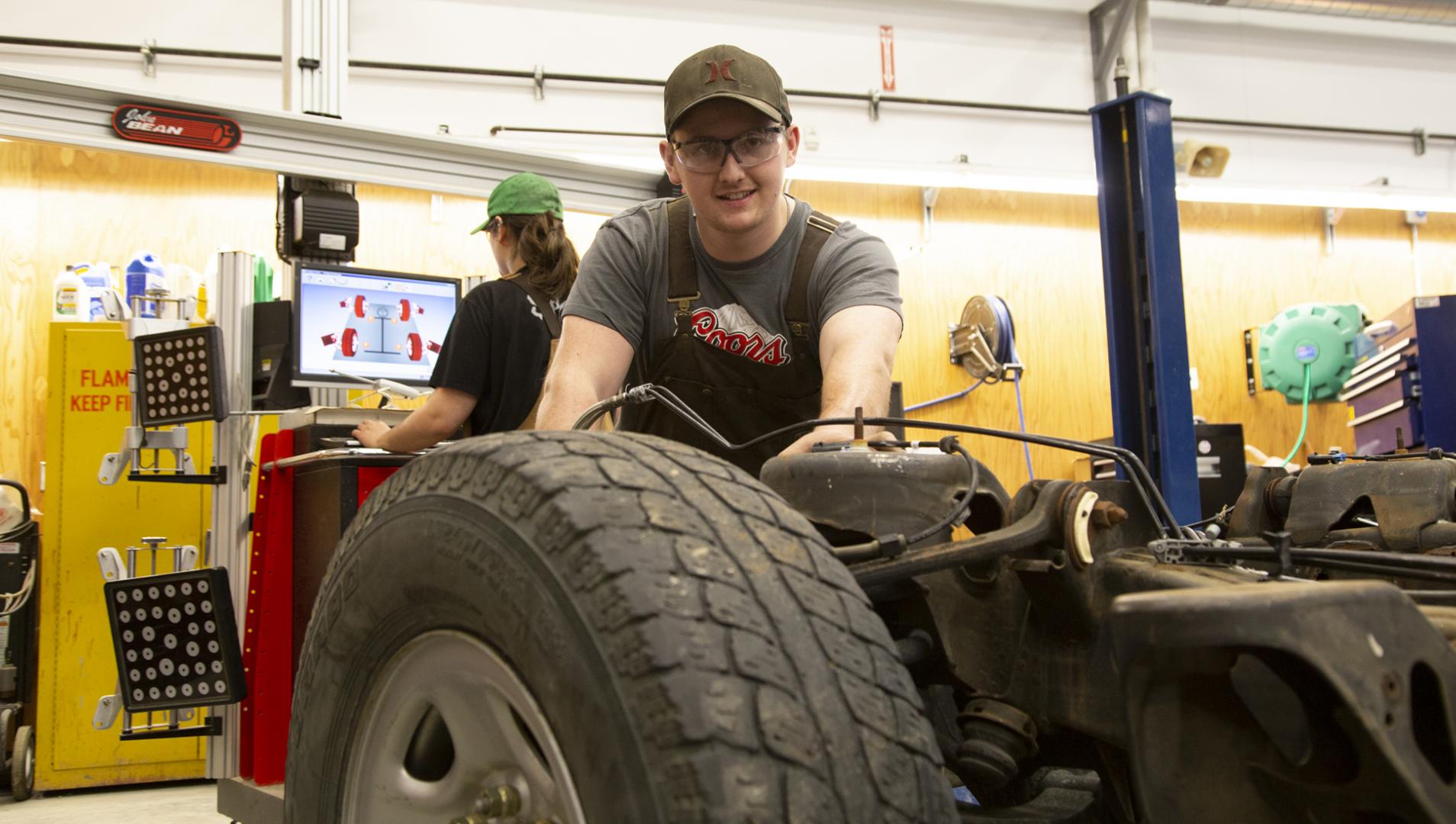 student working on a vehicle