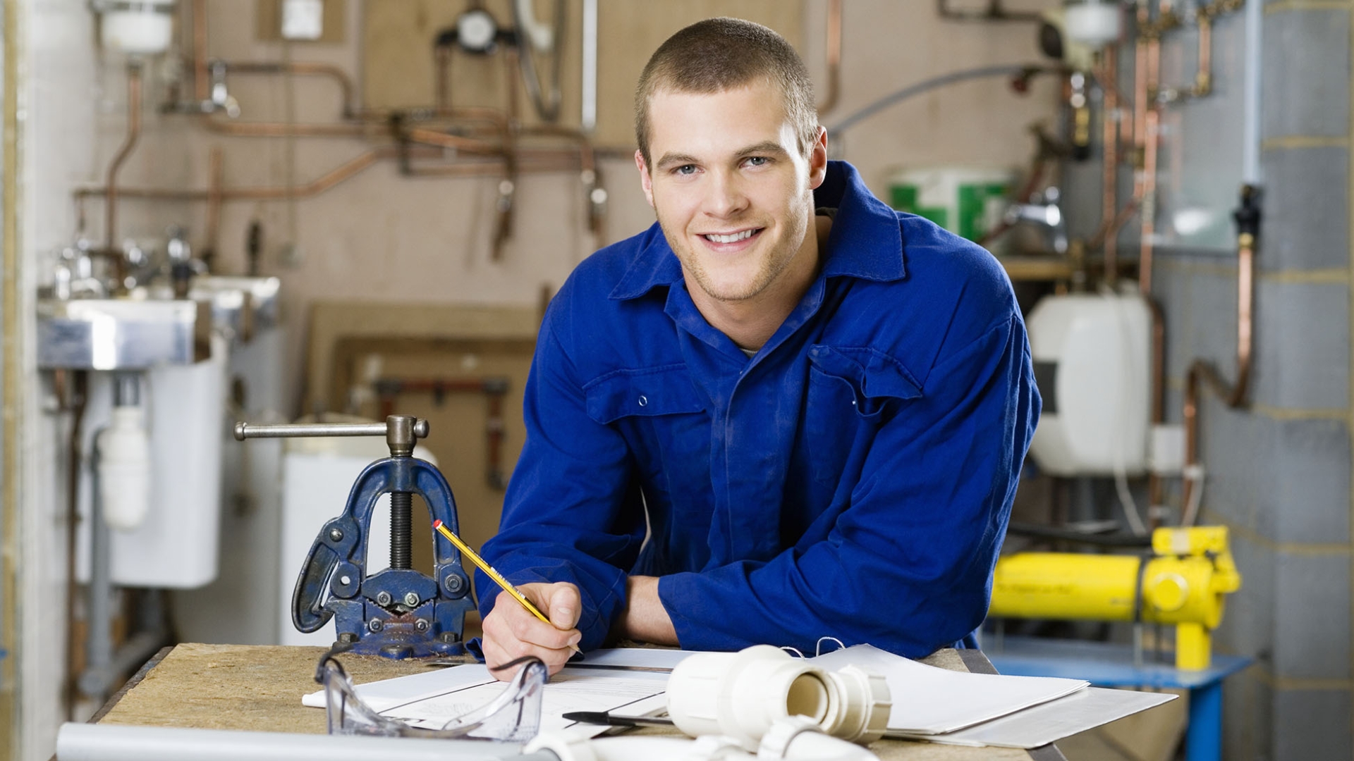 Plumber writing in a binder