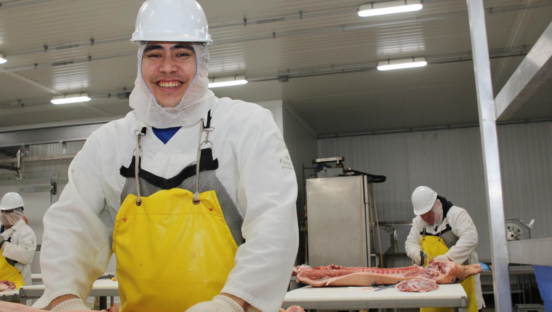 Assiniboine Student prepares meat in class