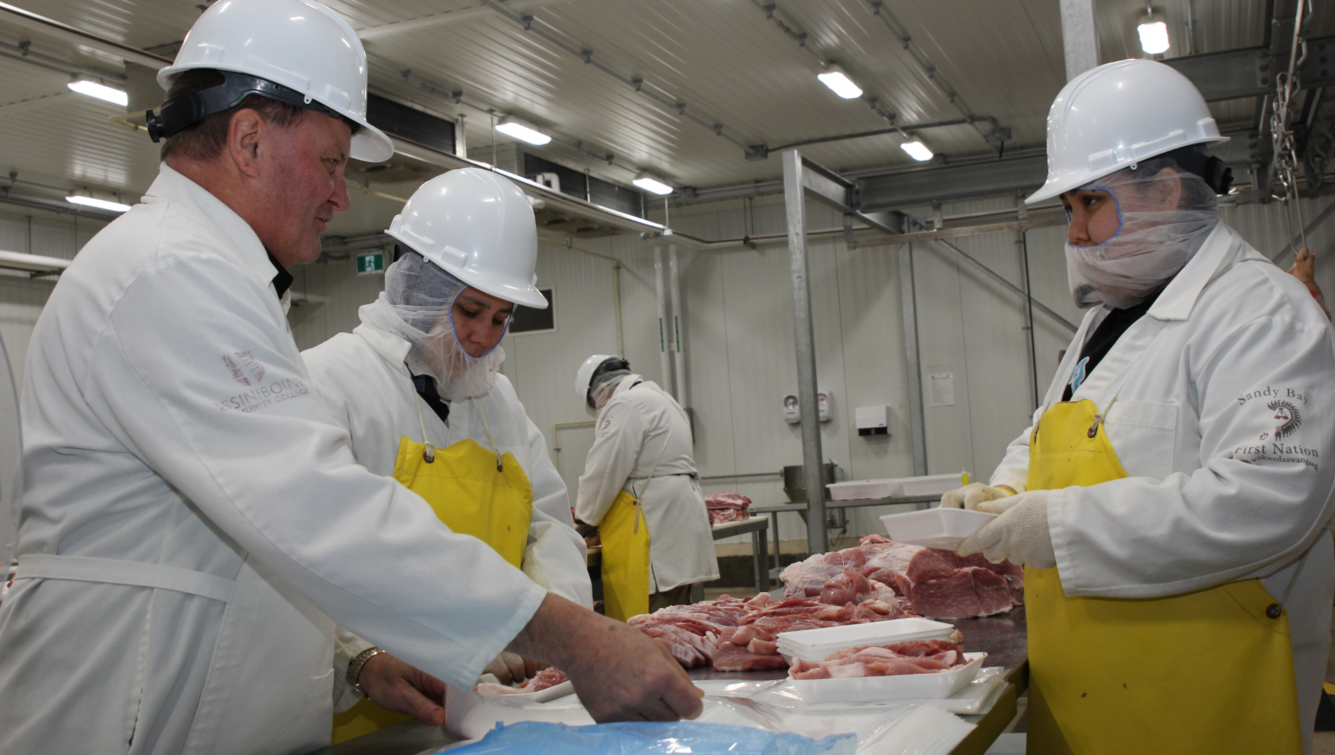 Assiniboine Instructor demonstrates correct meat handling techniques