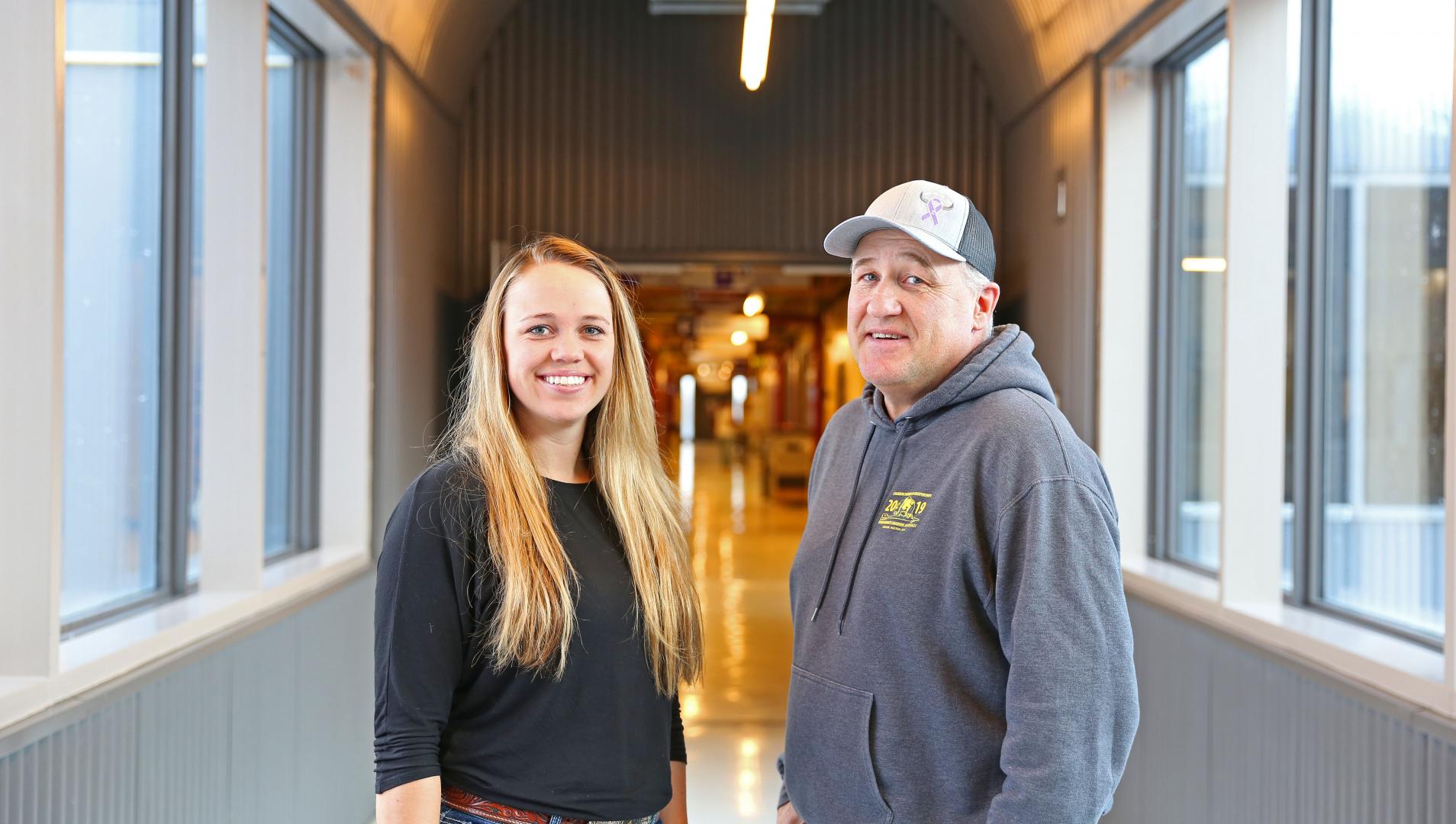 Tim and Kylie Gompf pose in the hallway at Assiniboine, where they both took agriculture programs