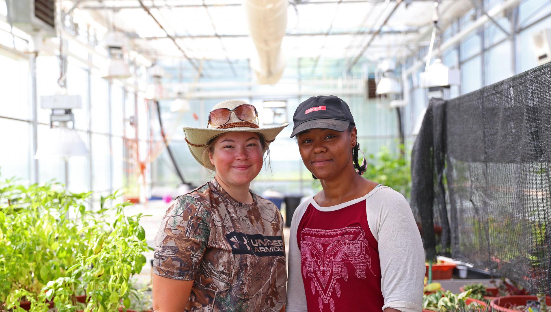 Truthwaite and Salemon in an Assiniboine greenhouse during their summer employment between years of study