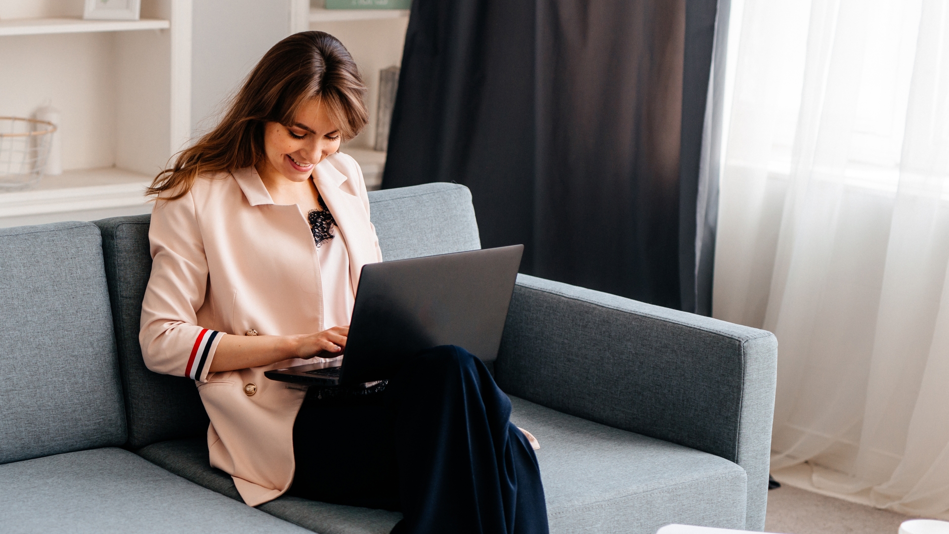 Woman sitting on a couch on a laptop