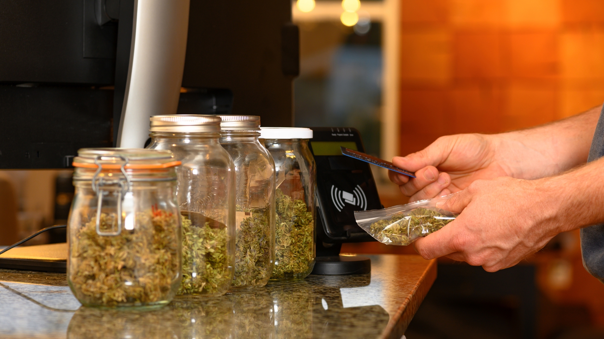 Pair of hands pictured, paying for cannabis