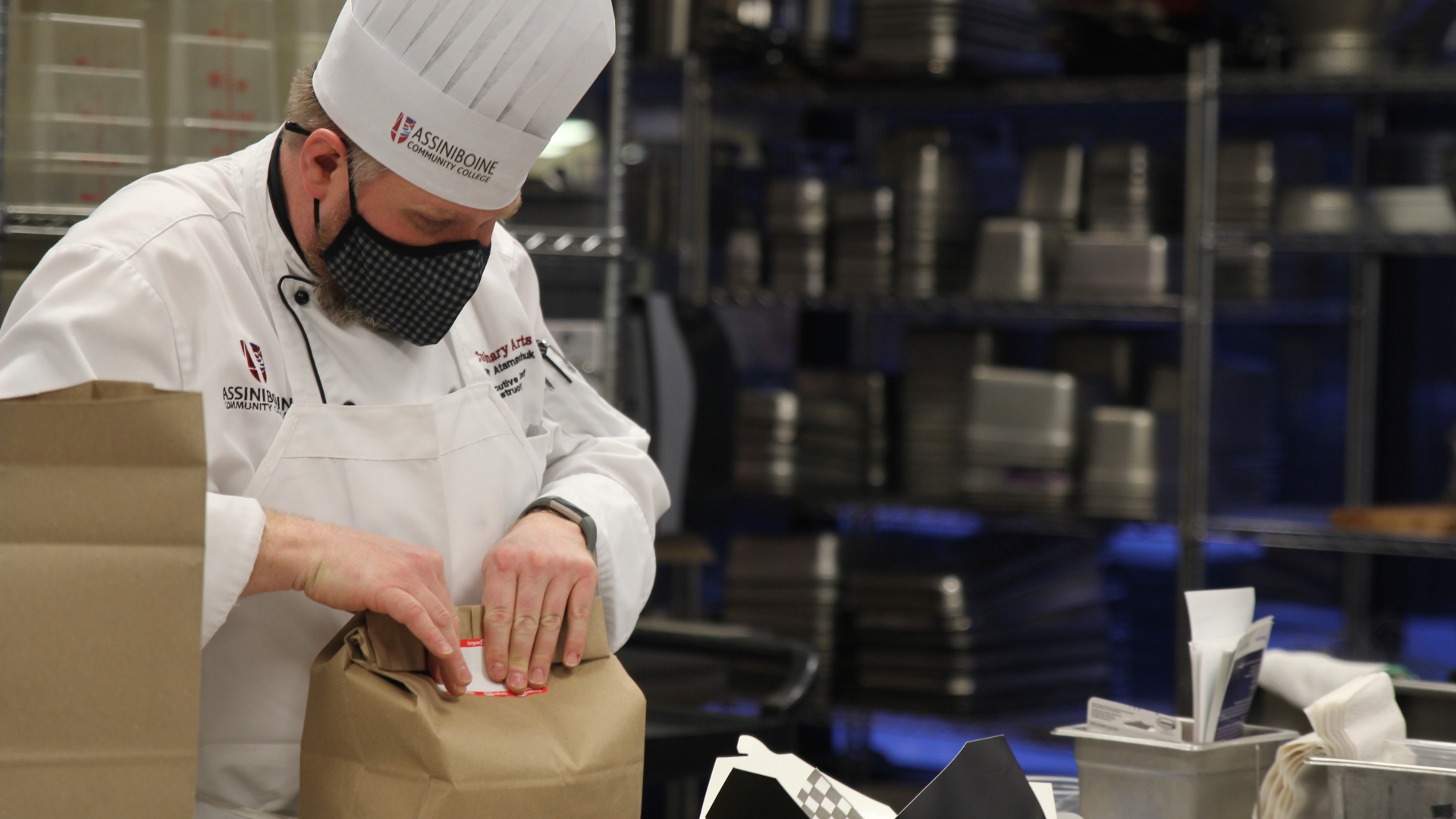 Chef Trevor Atamanchuk helps students box up delivery orders at Great Grey Owl 2021