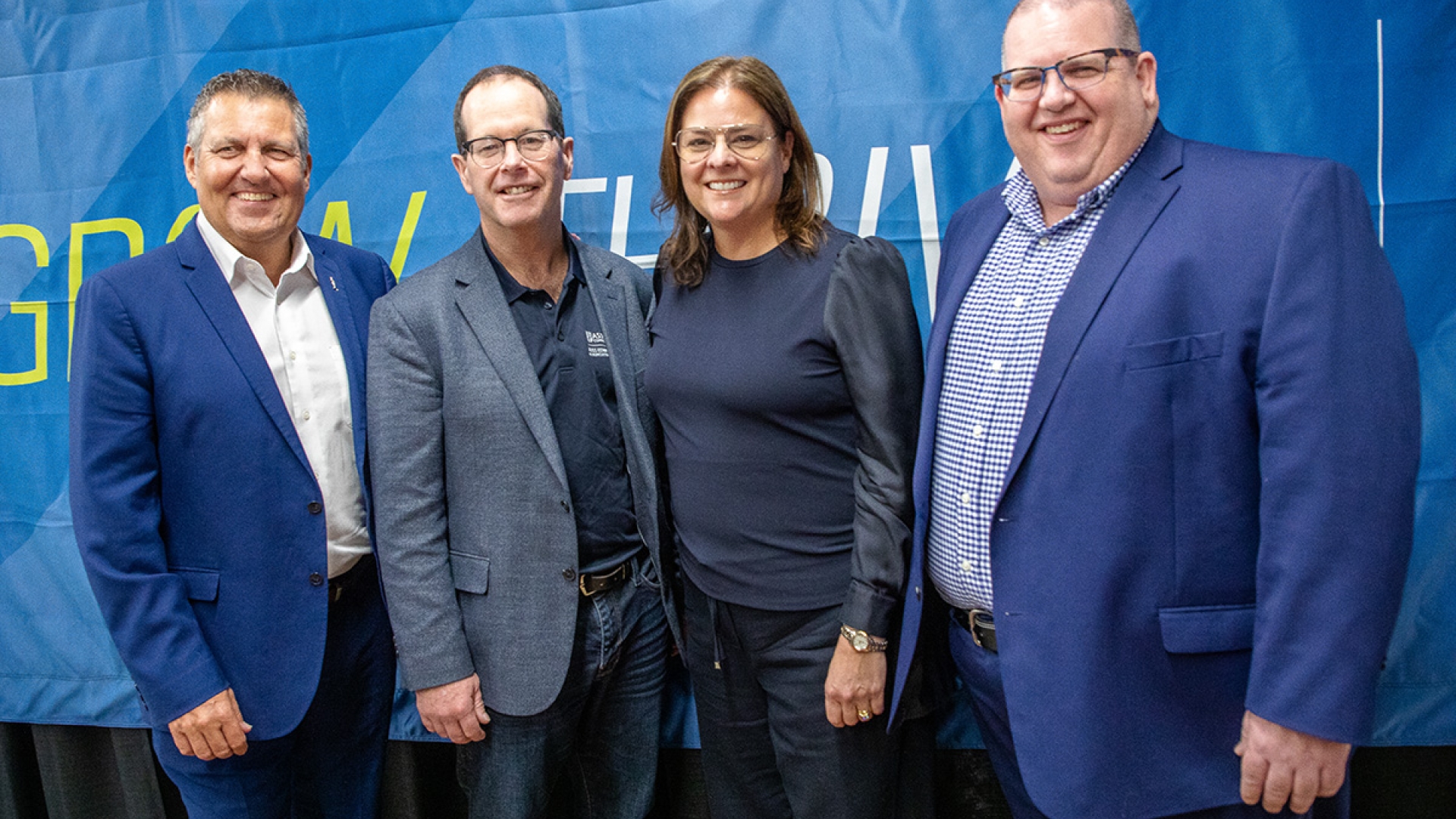 L-R (standing in front of a blue backdrop): Honourable Cliff Cullen, Deputy Premier of Manitoba;  Tim Hore, Dean, Russ Edwards School of Agriculture and Environment, Assiniboine; Honourable Heather Stefanson, Premier of Manitoba;  Mark Frison, President, Assiniboine 