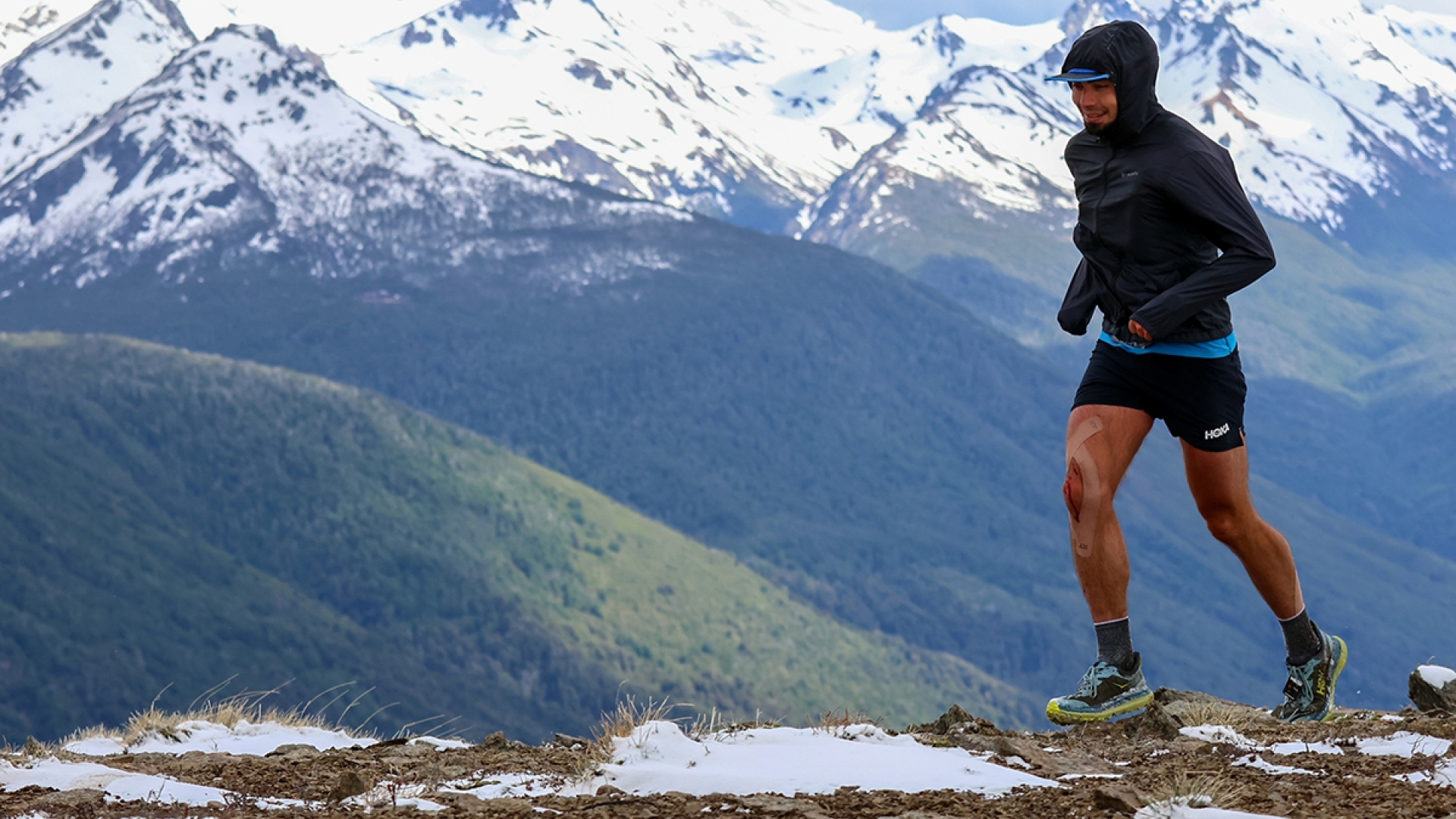 Ihor Verys running on a hill, with mountains and valleys in the background.