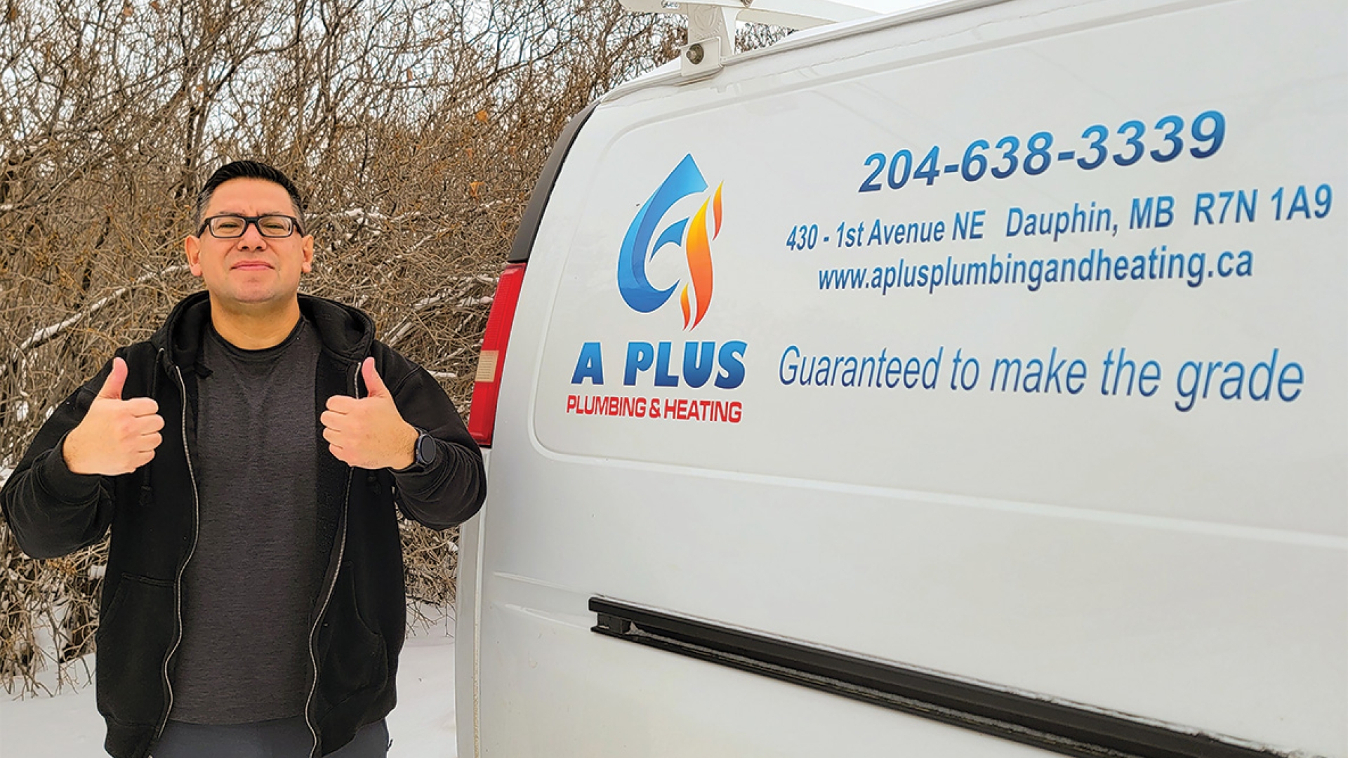 Ashley Houle standing in front of his van with A Plus Plumbing and Heating logo.