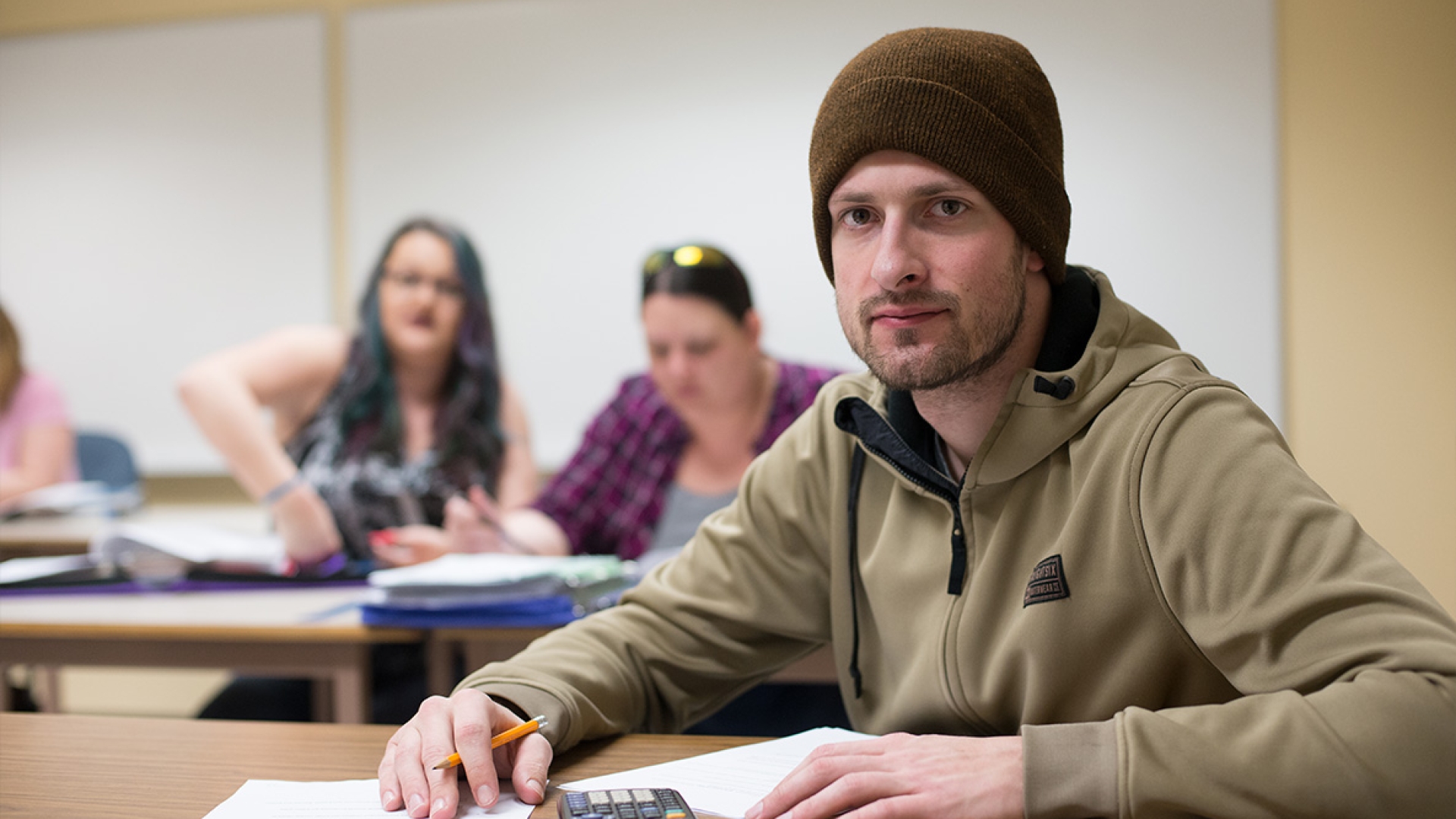A student sitting in a classroom.