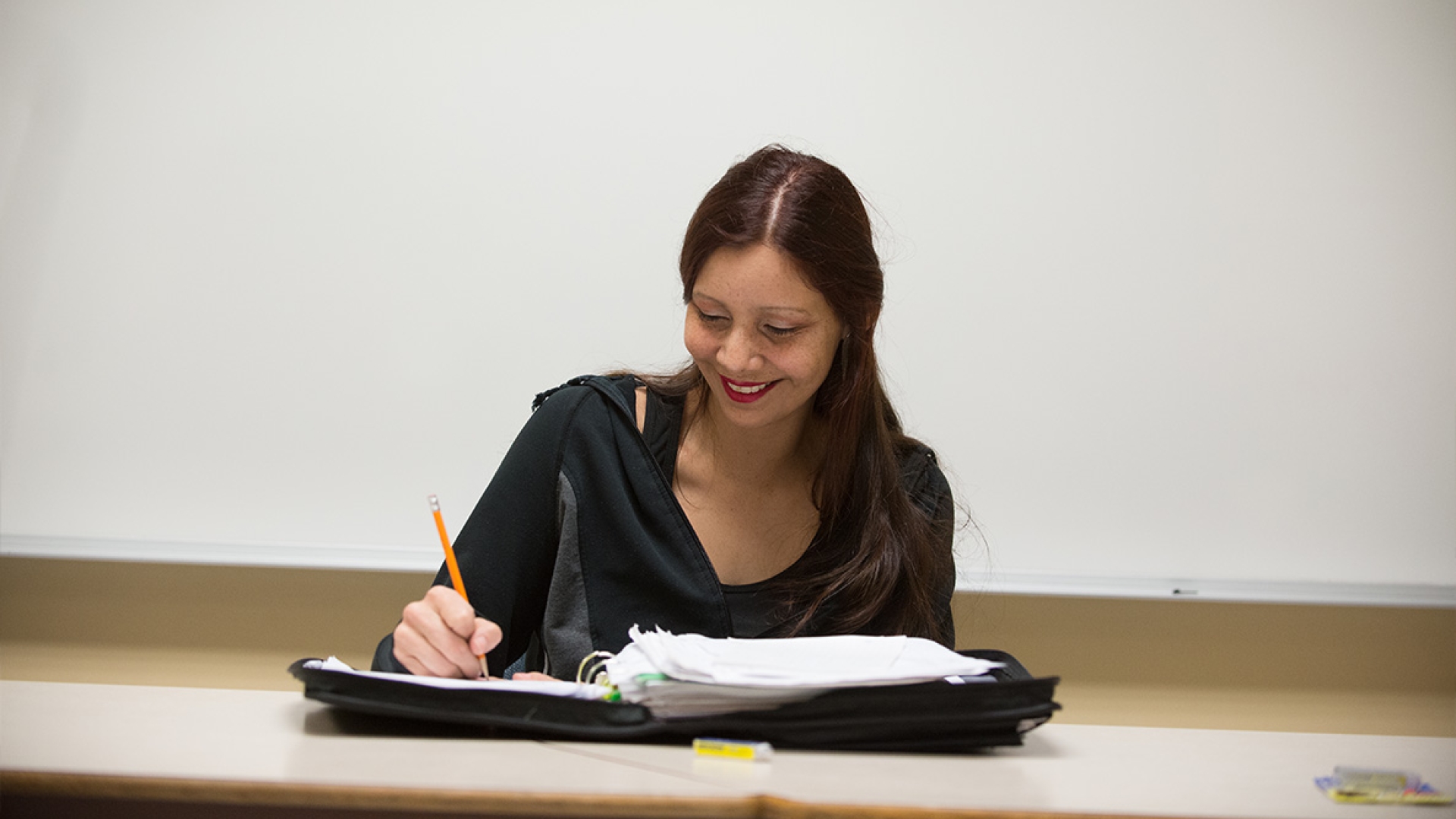 A student writing in her notebook.