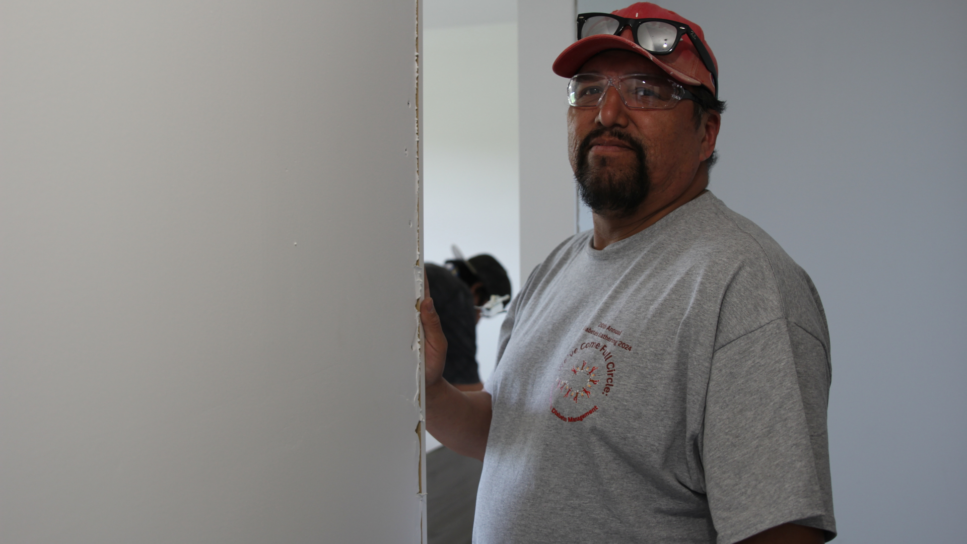 male student installing drywall