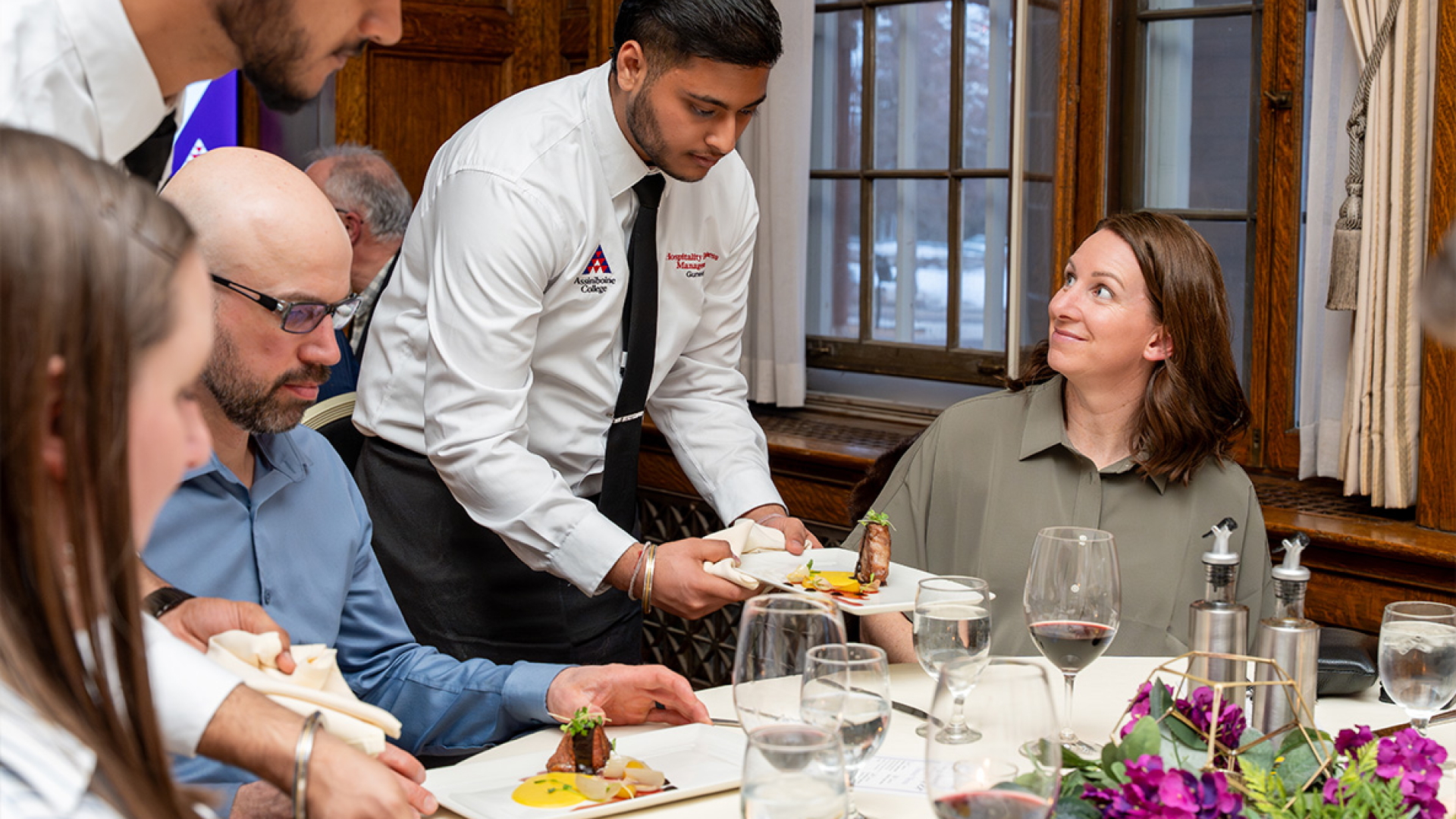 Assiniboine student serving food to guests during the Legacy Gala.