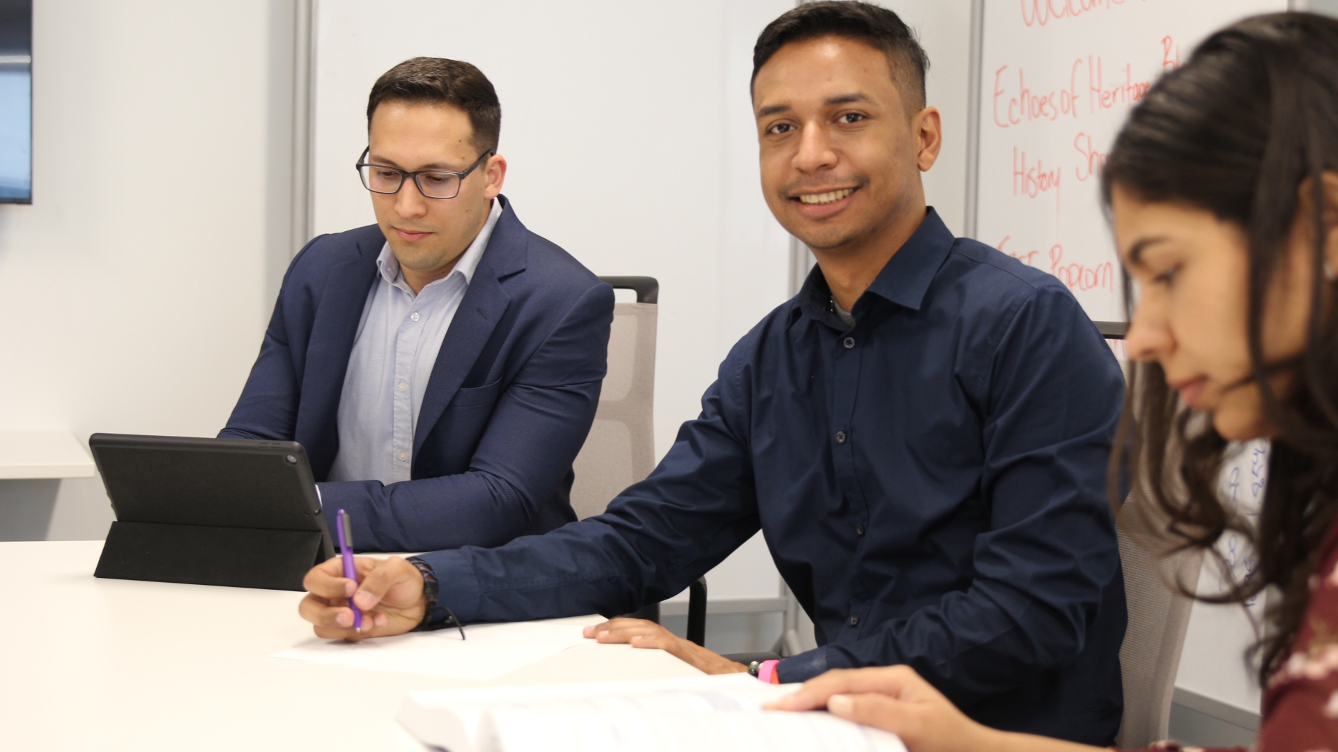 three students and one male student smiling at the camera