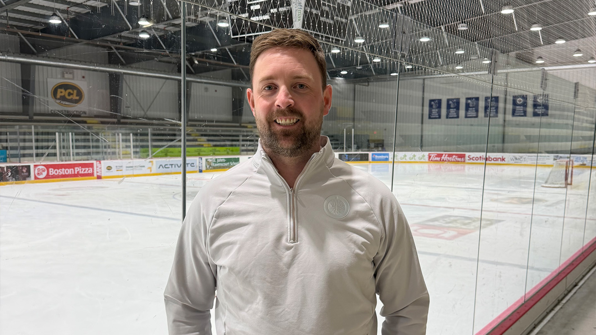 David Sattler standing in front of an ice rink.