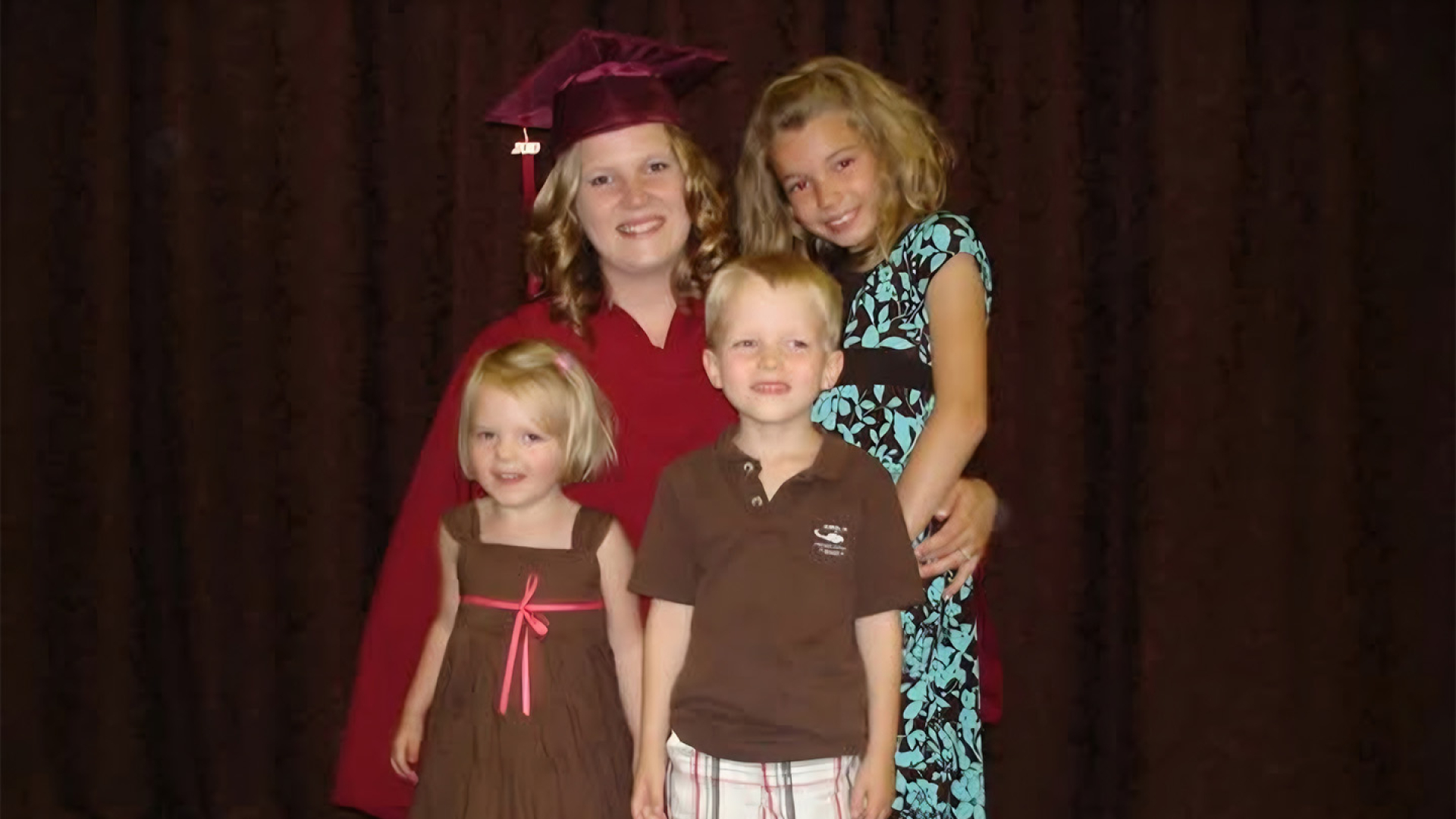 Krista Derksen posing with her kids at her graduation.