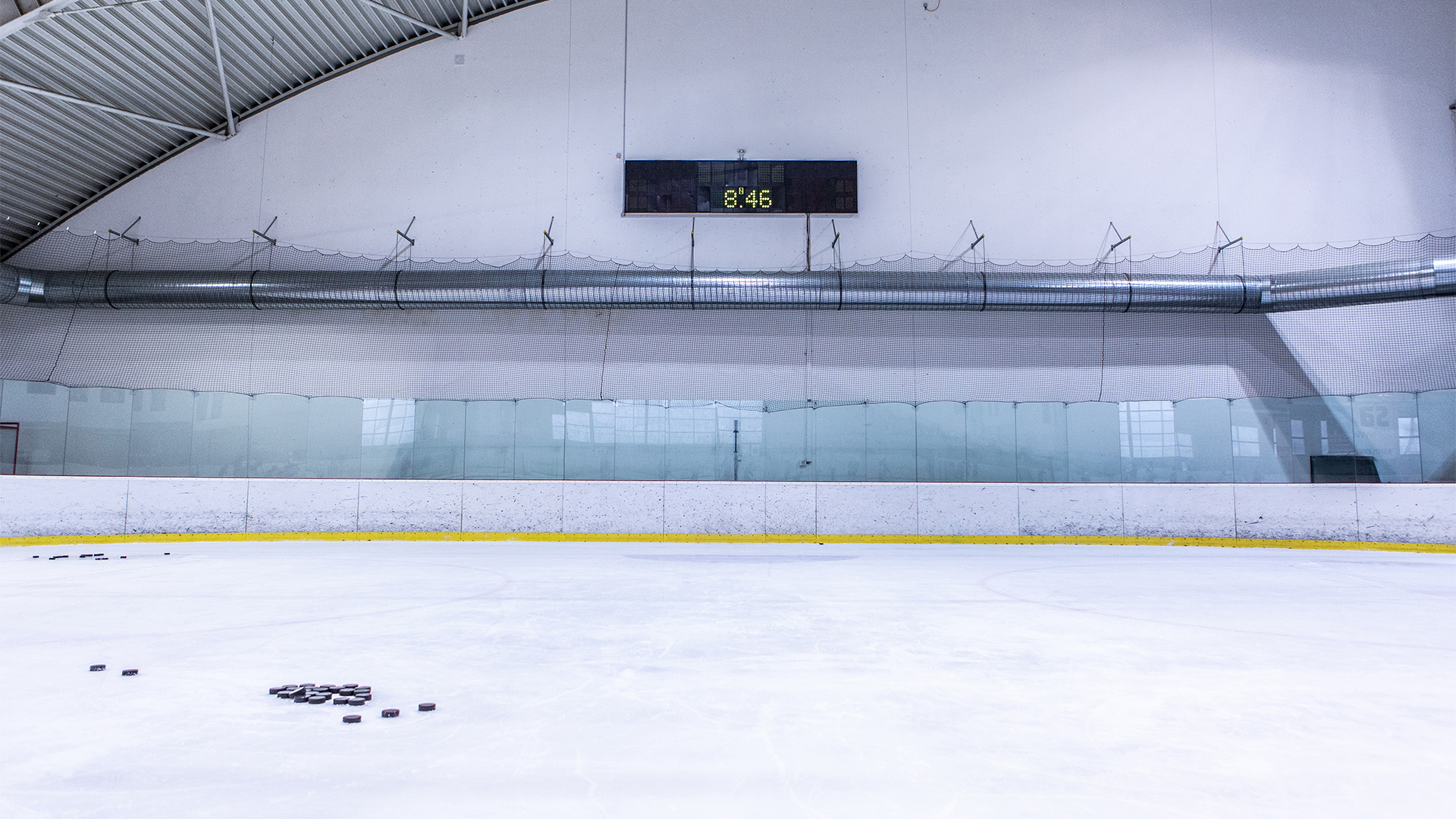 Indoor ice rink with hockey markings.