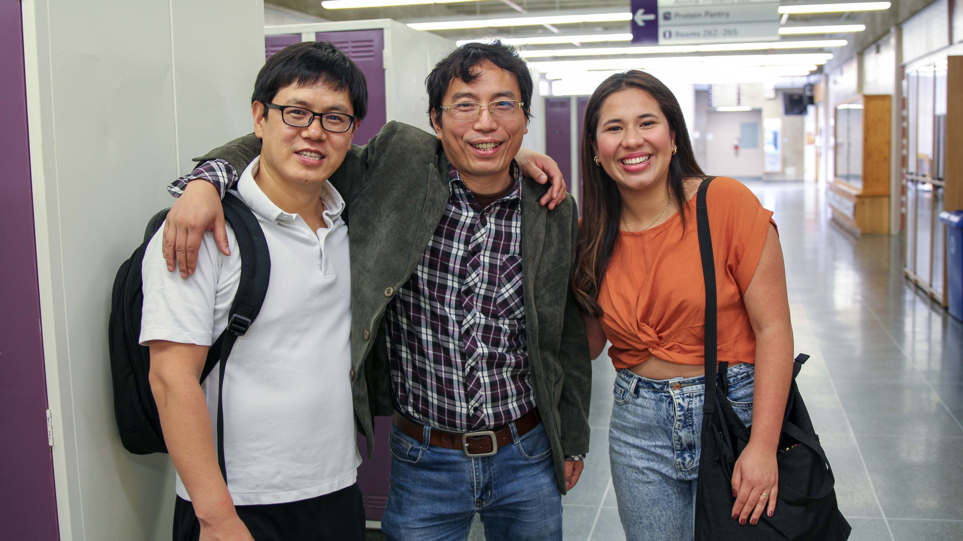 Three international students in hallway.