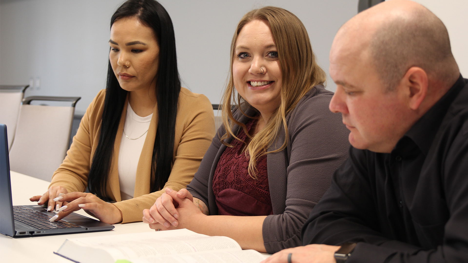 Three business administration students studying together.