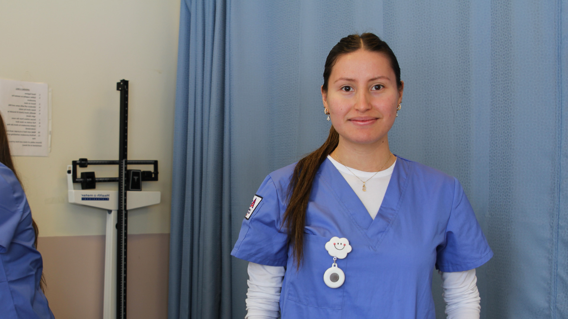 CHCA student in blue scrubs.