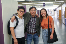 Three international students in hallway.